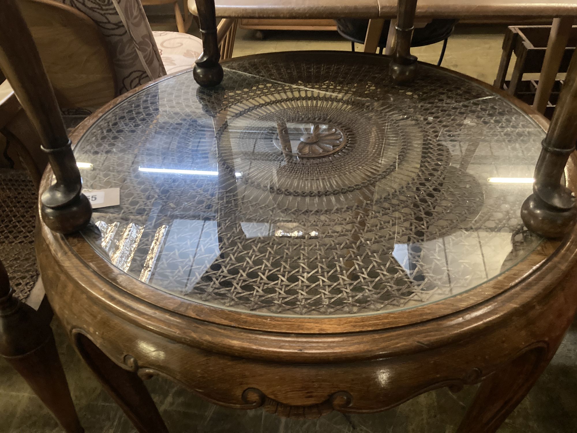 A 1920s circular caned beech occasional table, diameter 76cm, together with a pair of elbow chairs, one with a later tapestry seat